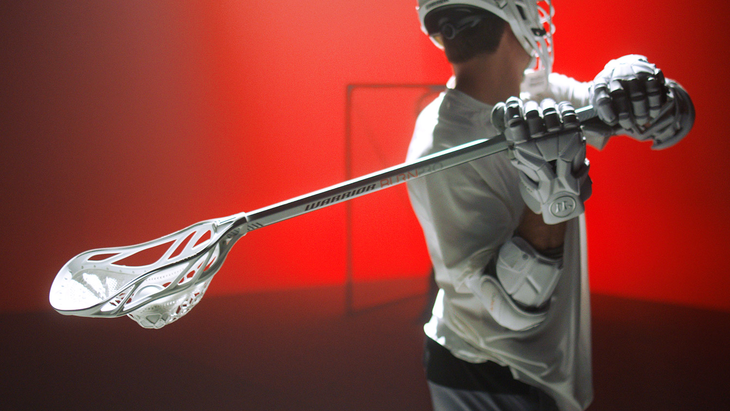 A still photograph from an advertising video production with Warrior Sports, show casing their Burn Warp Pro 2 lacrosse stick. Captured in studio by production company, Unrivaled.