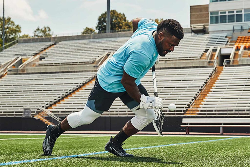 Trevor Baptiste, a professional athlete, during a peak action moment that shows a close up of New Balance's latests footwear and sports cleat for lacrosse. Photographed and produced by Unrivaled in Baltimore, MD.