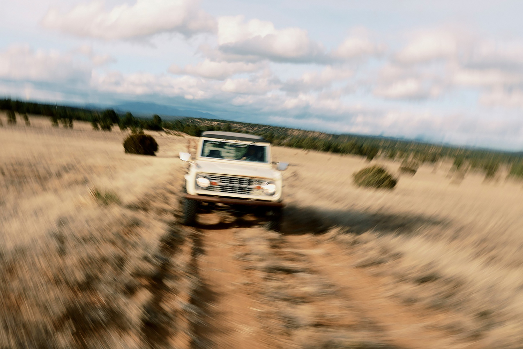 An off roach vehicle travels through the Texas ruggedness. The camera shows movement, giving the feeling that the truck is rocking back and forth.