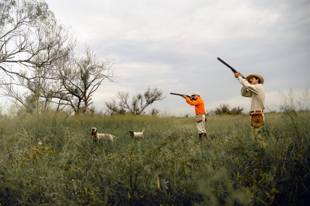 Two hunters and their dogs hunt on a ranch in Texas. Captured by photographer, Travis Gillett.
