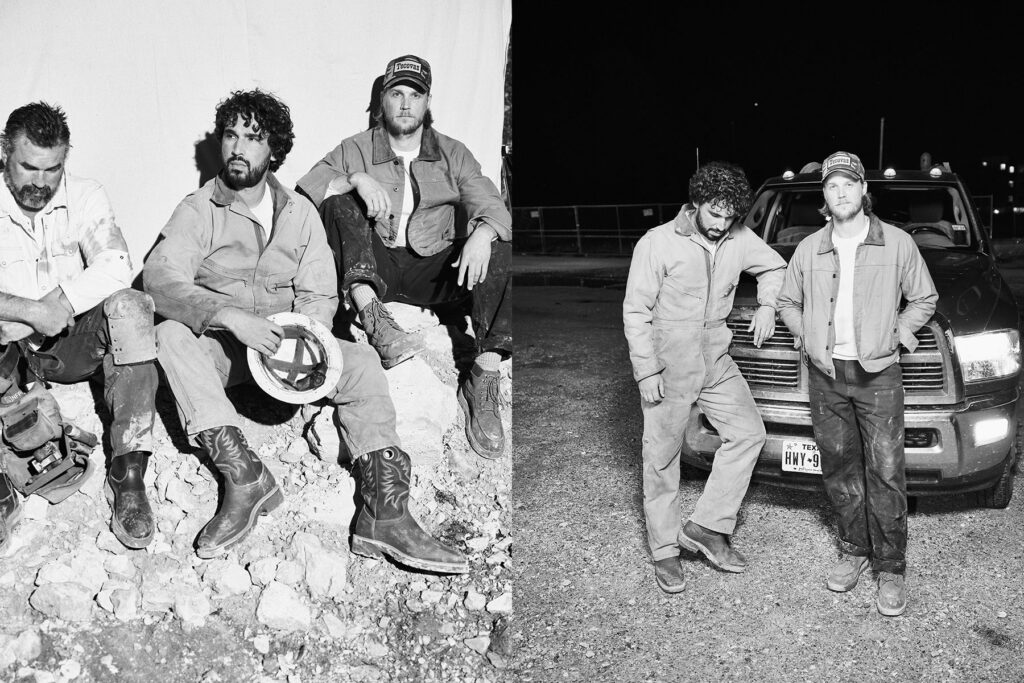 Two constructions workers pose for a portrait after a shift in the parking lot of a bar or honky tonk in Texas.