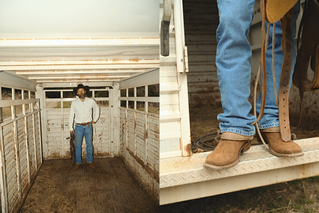 A man wearing a cowboy hat, white shirt, and blue jeans stands in a worn, empty livestock trailer. Captured by a commercial photographer, the industrial scene includes a close-up of his boots on the metal step as he holds tack.
