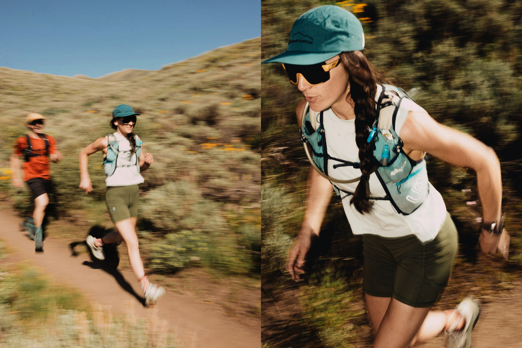 Two people trail running outdoors on a dirt path through green, hilly terrain. The focus is on a woman in a teal hat and sunglasses, wearing a hydration pack, running energetically with a man in orange behind her.