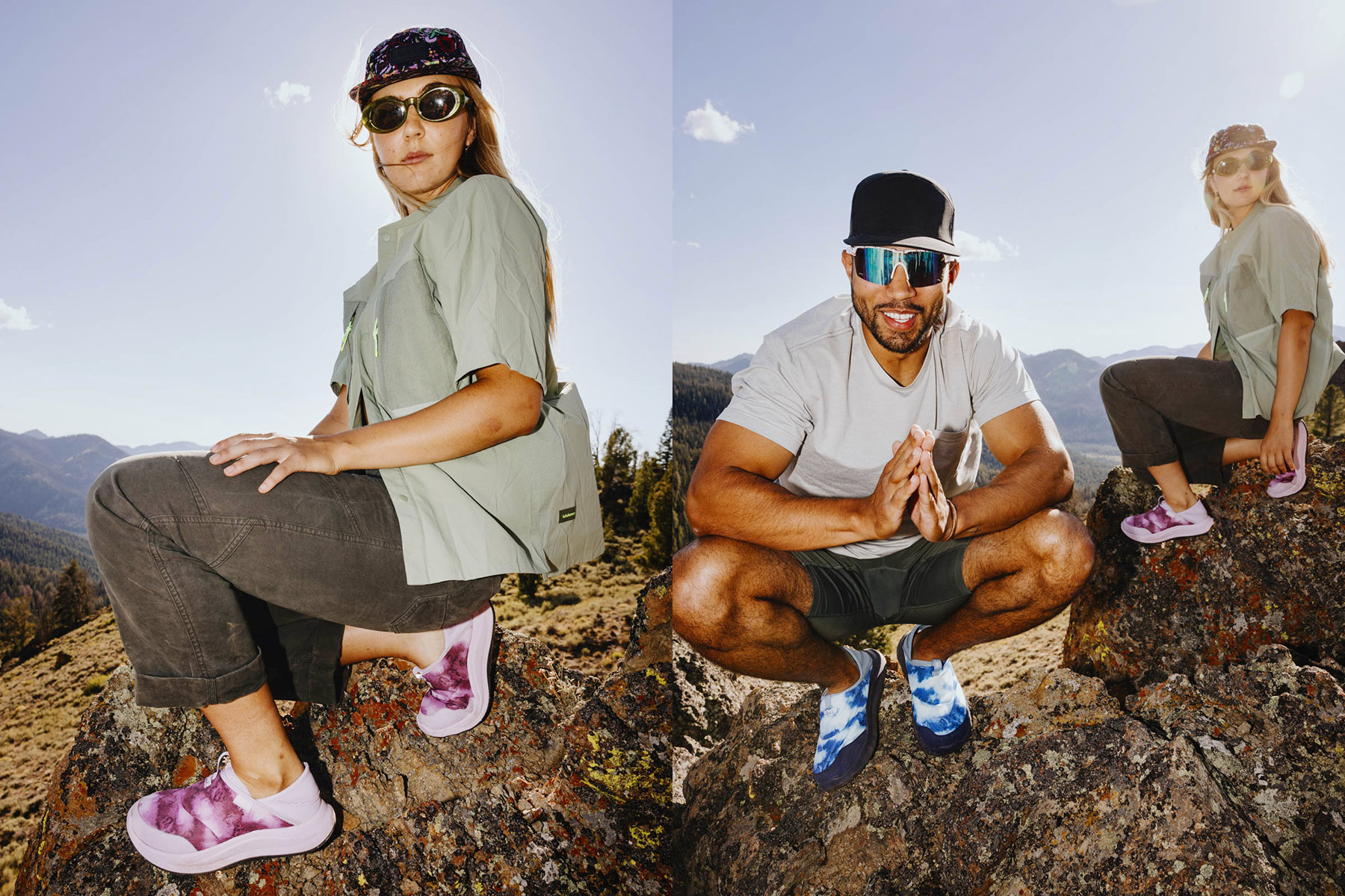 Two people wearing casual outdoor clothing and colorful slip-on shoes sit on rocky terrain with mountains in the background, enjoying a sunny day. The woman wears purple shoes; the man wears blue shoes and sunglasses.