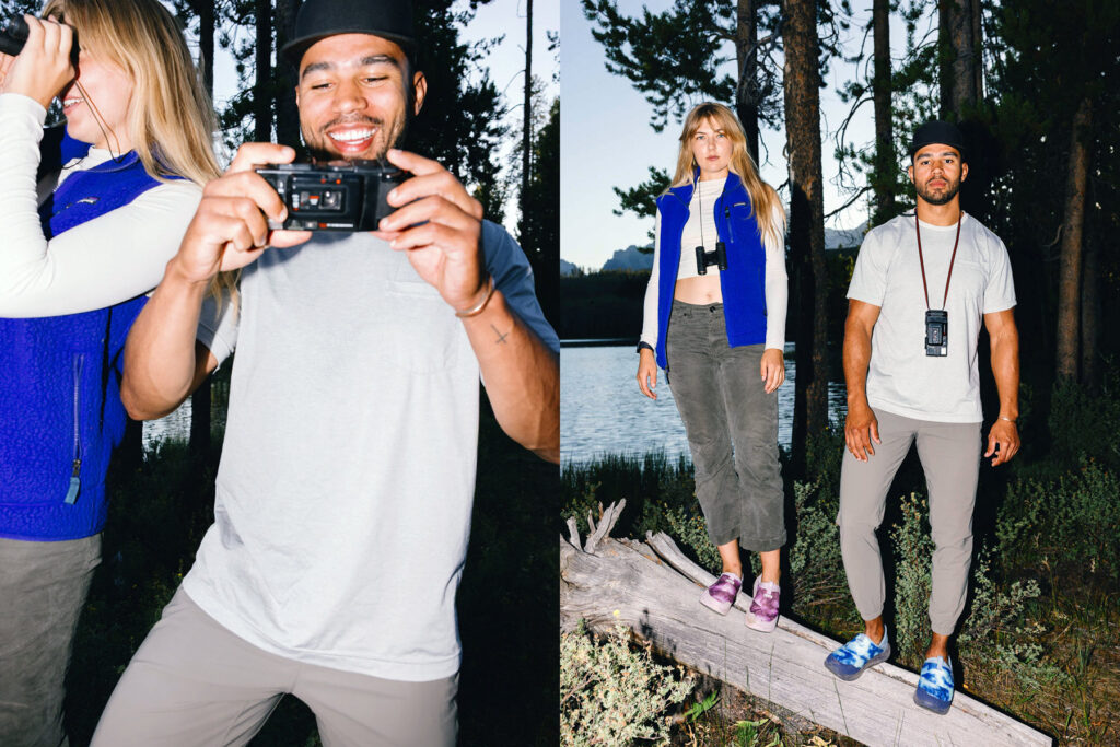 Two people outdoors near a lake and trees; on the left, a man smiles while taking a photo, and a woman looks through binoculars. On the right, they stand side by side on a log, dressed in casual outdoor clothing.