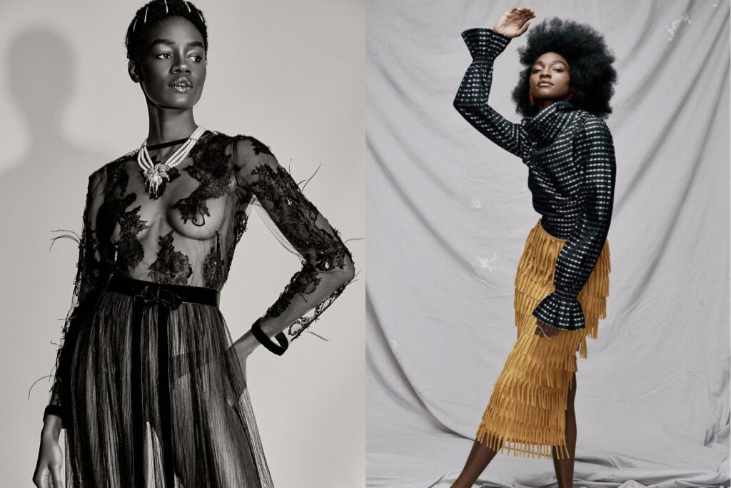 Two models pose stylishly: the left wears a sheer, embroidered black gown with a statement necklace; the right wears a textured black top with flared sleeves and a fringed yellow skirt, standing against a draped fabric backdrop.